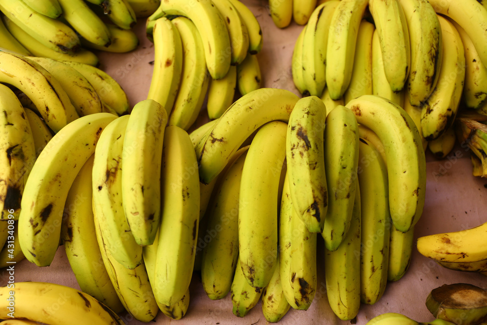 Banana bunches on grocery shelf.