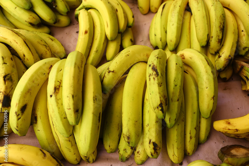 Banana bunches on grocery shelf.