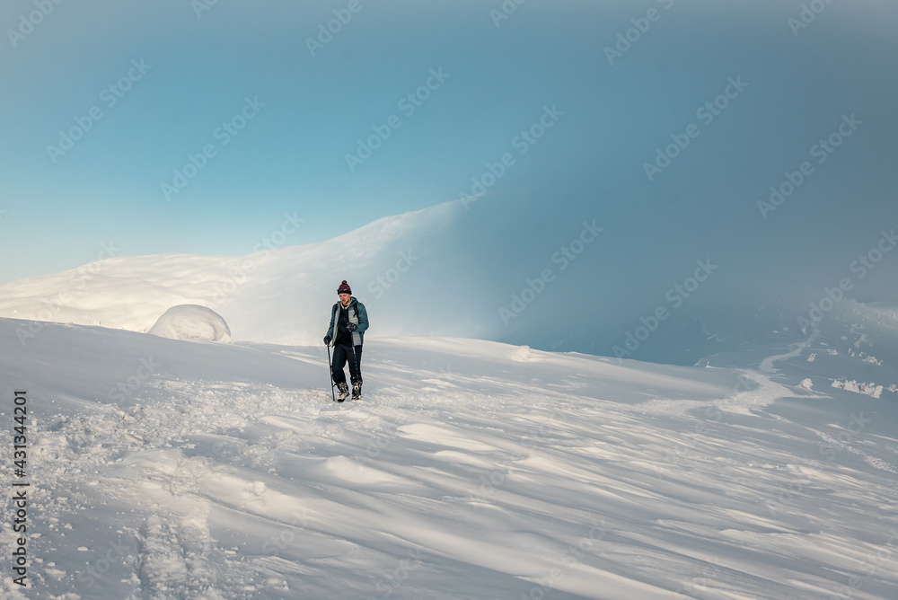 man tourist in winter mountains