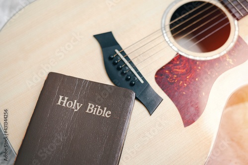 Christians worship God with a guitar with the Holy Bible. reading the Bible and sharing the gospel with copy space for the word of god.