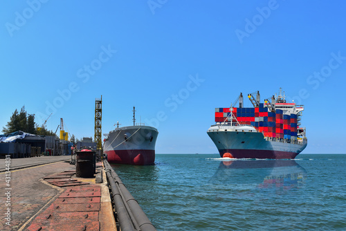 Container cargo ships in export, import and logistics business, cargo ship moored alongside in jetty