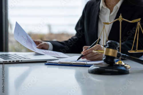 Lawyer office. Statue of Justice with scales and lawyer working on a laptop. Legal law, advice and justice concept