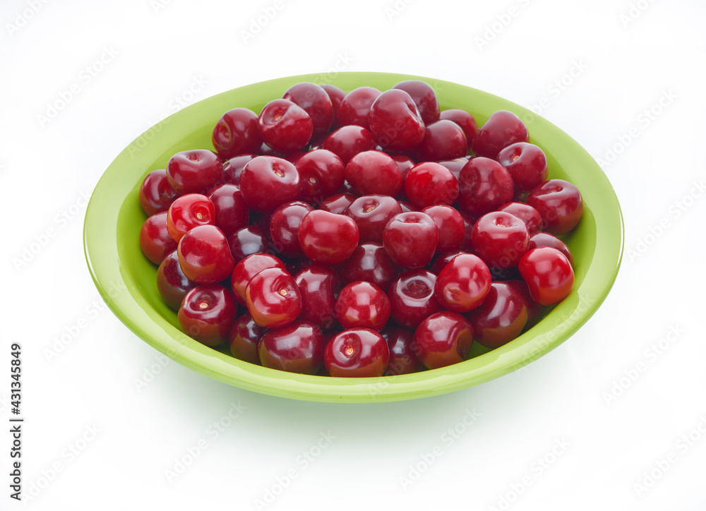 Sweet fresh cherry on color plate isolated on white background Sweet fresh cherry on color plate isolated on white background