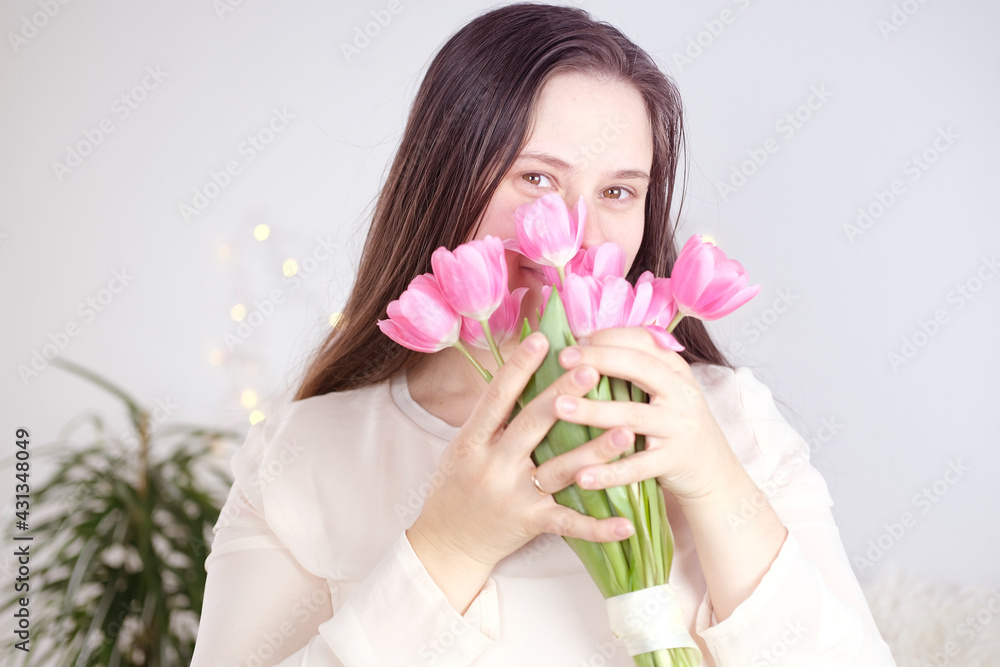 young woman, girl with long blond hair holds bouquet of pink tulips in her hands, light toned photo, concept spring, mother's day, valentine's, birthday, holiday young woman, girl with long blond hair holds bouquet of pink tulips in her hands, light toned photo, concept spring, mother's day, valentine's, birthday, holiday