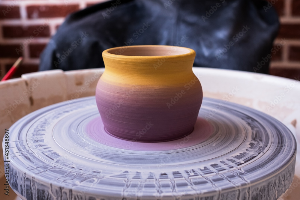 Close up view on just made ceramic on potter wheel. Close up view on just made ceramic on potter wheel.