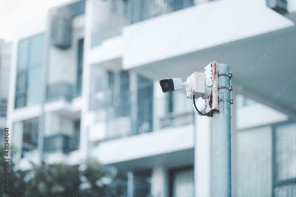 CCTV. video surveillance camera is mounted on a pole outside an apartment building. CCTV. video surveillance camera is mounted on a pole outside an apartment building.