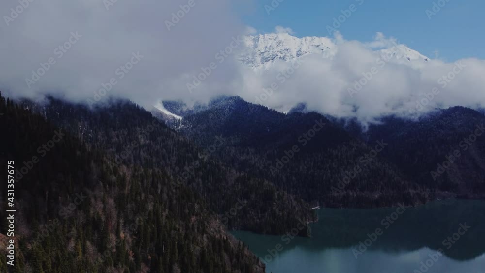Stunning Aerial View of the Mountain Landscape in Cloudy Day. Drone Flight above Low Hanging Clouds Blanketing a Valley. Stunning Aerial View of the Mountain Landscape in Cloudy Day. Drone Flight above Low Hanging Clouds Blanketing a Valley.