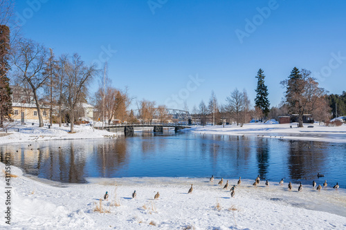 View to The Lake Saimaa and bridge to The Olavinlinna Castle from the shore in winter, Savonlinna, Finland photo