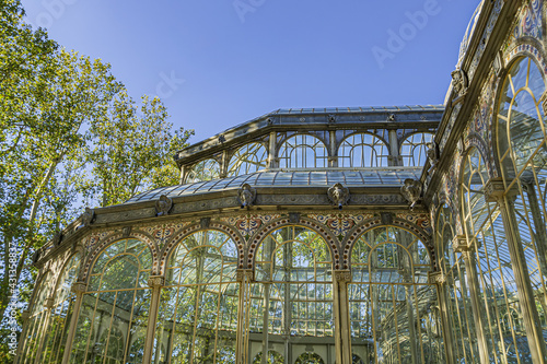 Crystal Palace (Palacio de Cristal) in the Public Retiro Park in Madrid. Crystal Palace built in 1887 to exhibit flora and fauna from the Philippines. Madrid, Spain.