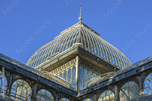 Crystal Palace (Palacio de Cristal) in the Public Retiro Park in Madrid. Crystal Palace built in 1887 to exhibit flora and fauna from the Philippines. Madrid, Spain.