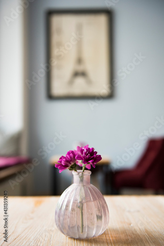 flowers on the table with a picture of Eiffel Tower