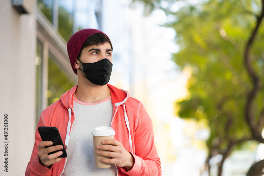 Young man using his mobile phone outdoors. Young man using his mobile phone outdoors.