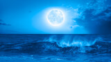 Full moon rising over empty ocean at night 