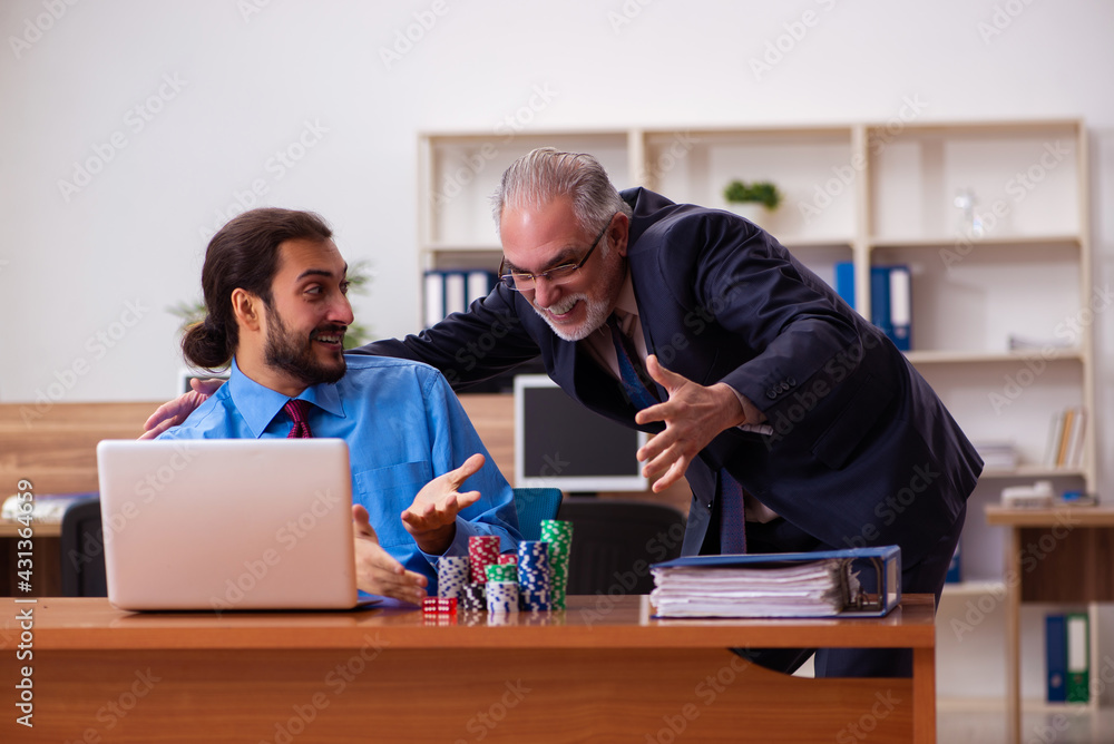 Two male employees in gambling concept Two male employees in gambling concept