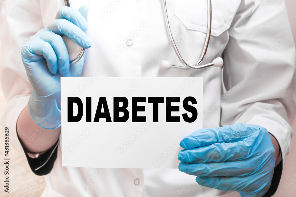 the doctor in gloves holds a card with the text DIABETES . white background. the medicine the doctor in gloves holds a card with the text DIABETES . white background. the medicine