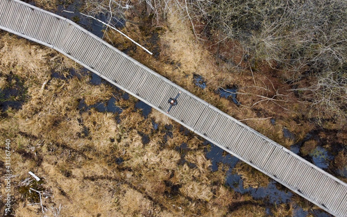 Photography Berlin, Germany - 28 April 2021: Wooden bridge across the marshland from above