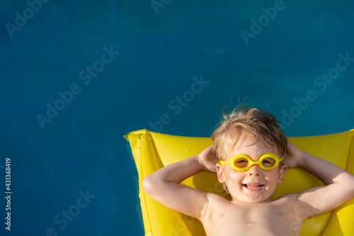 Happy child swimming on summer vacation