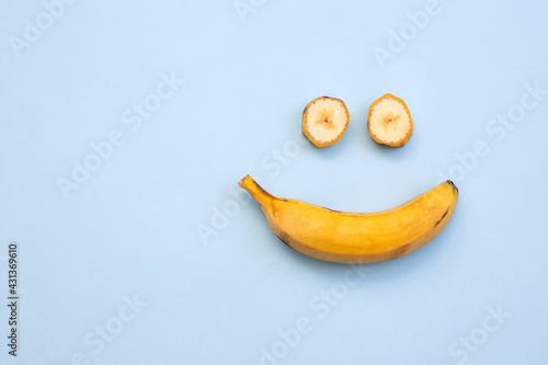 Funny flat lay composition with bananas on blue background