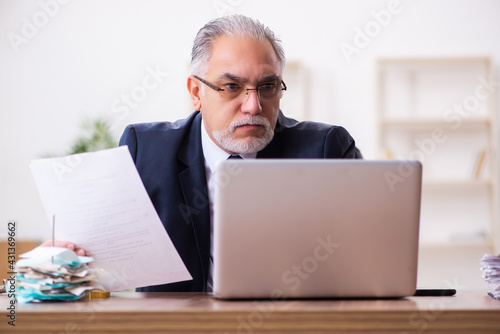 Old businessman employee in budget planning concept