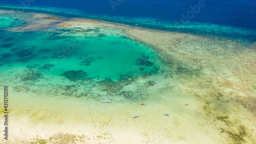 Atoll with turquoise water and boats view from above. Coral reef and blue sea. Coral reef and blue sea. Bohol,Philippines.