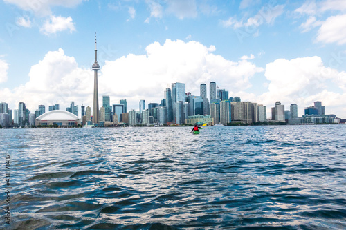 Sea kayakers paddle from the Toronto Islands across the Inner Harbour to Harbourfront Centre and the CN Tower.