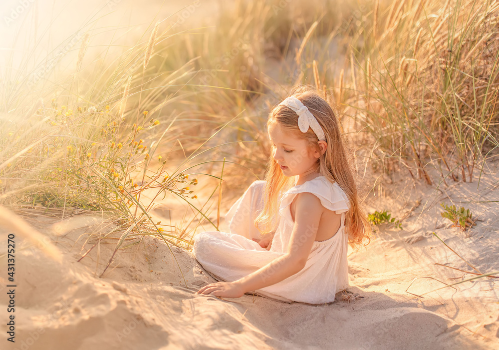 Beautiful little girl with long hair at the beach in summer. Summer vacations with kids concept. Beautiful little girl with long hair at the beach in summer. Summer vacations with kids concept.