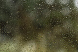 Raindrops on the glass window as a background. Close-up