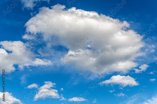 Blue sky with white beautiful clouds as an abstract background.