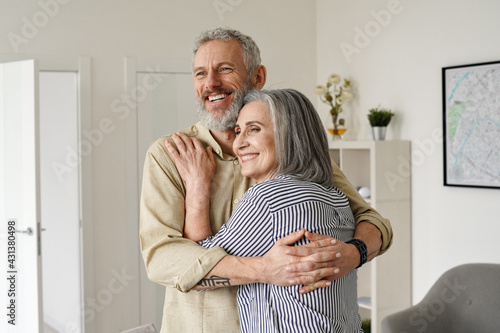 Принти на полотні Happy senior adult mature classy couple hugging, bonding, thinking of good future