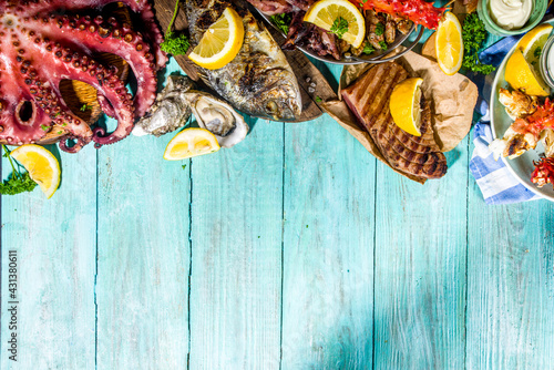 Assortment various barbecue Mediterranean grill food - fish, octopus, shrimp, crab, seafood, mussels, summer diet bbq party fest, with kebab, sauces, light blue sunny wooden background