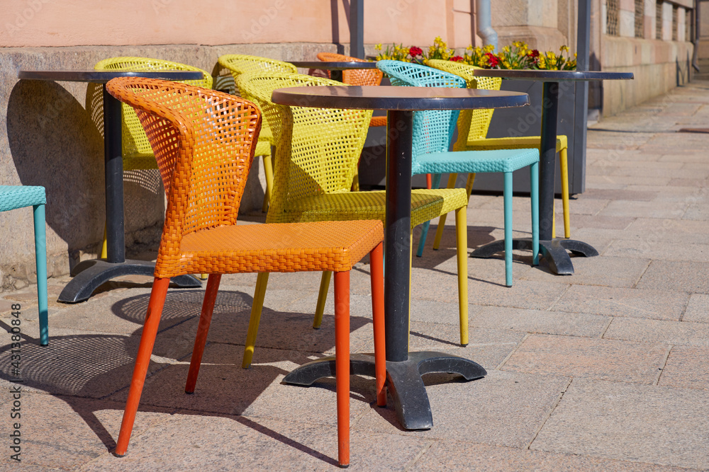 Multi-colored chairs on the street terrace of the cafe