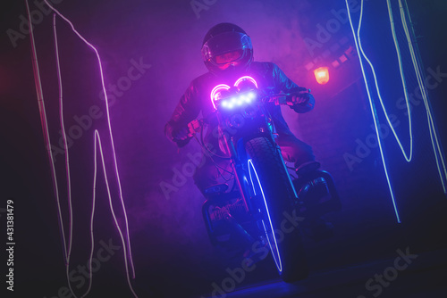 Motorbiker is riding a futuristic motorcycle on the night street concept.