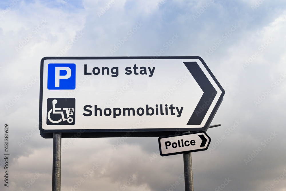 Obraz premium Directional sign for long stay parking, the shopmobility office and police station in a town centre.