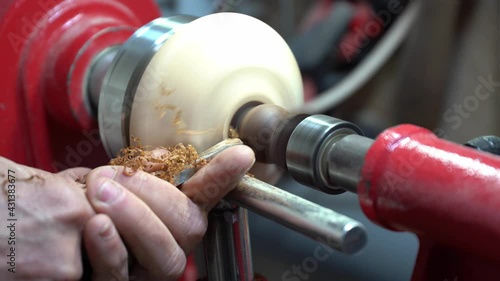 Joinery worker shaping a piece of wood on the lathe