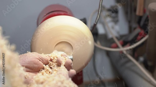 Joinery worker shaping a piece of wood on the lathe
