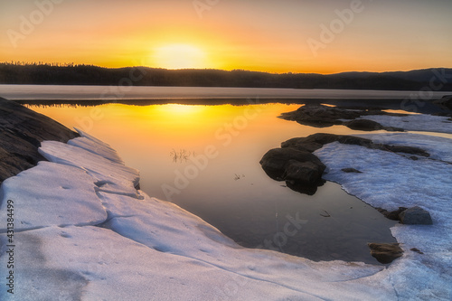 Sheets of ice and snow by Lake Vaeleren on a warm April evening photo