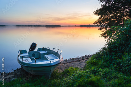 Masurian lake, sunset, motor boat