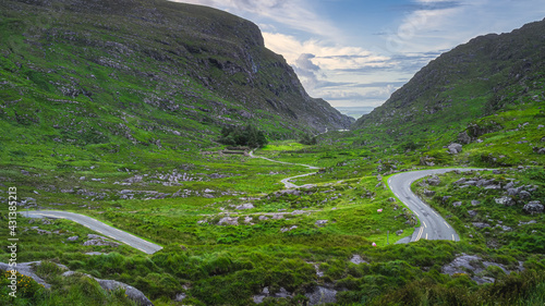 Beautiful landscape with winding narrow road running through Gap of Dunloe and Black Valley, MacGillycuddys Reeks mountains, Ring of Kerry, Ireland