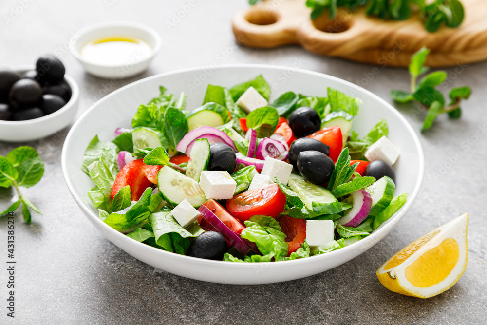 Fresh vegetable greek salad with lettuce, olives and feta cheese