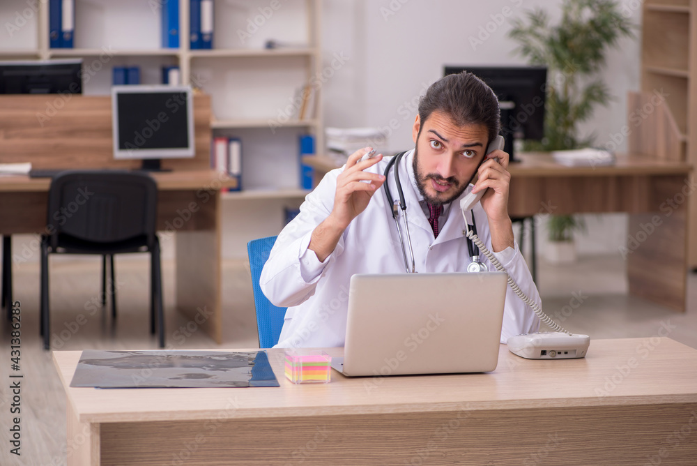 Young male doctor in telemedicine concept Young male doctor in telemedicine concept
