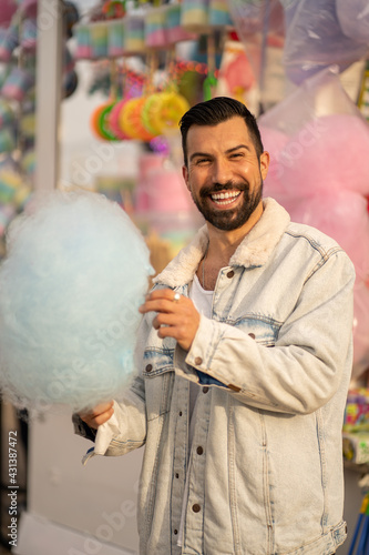 Guy eating cotton candy © Jesus