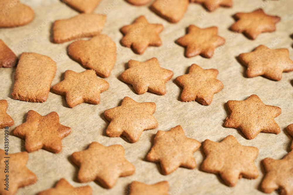 Star cookies on tray. Woman baked christmas biscuit. Many pieces of cake at paper. Holiday sweet food. Process prepare. Lot cinnamon desserts Star cookies on tray. Woman baked christmas biscuit. Many pieces of cake at paper. Holiday sweet food. Process prepare. Lot cinnamon desserts