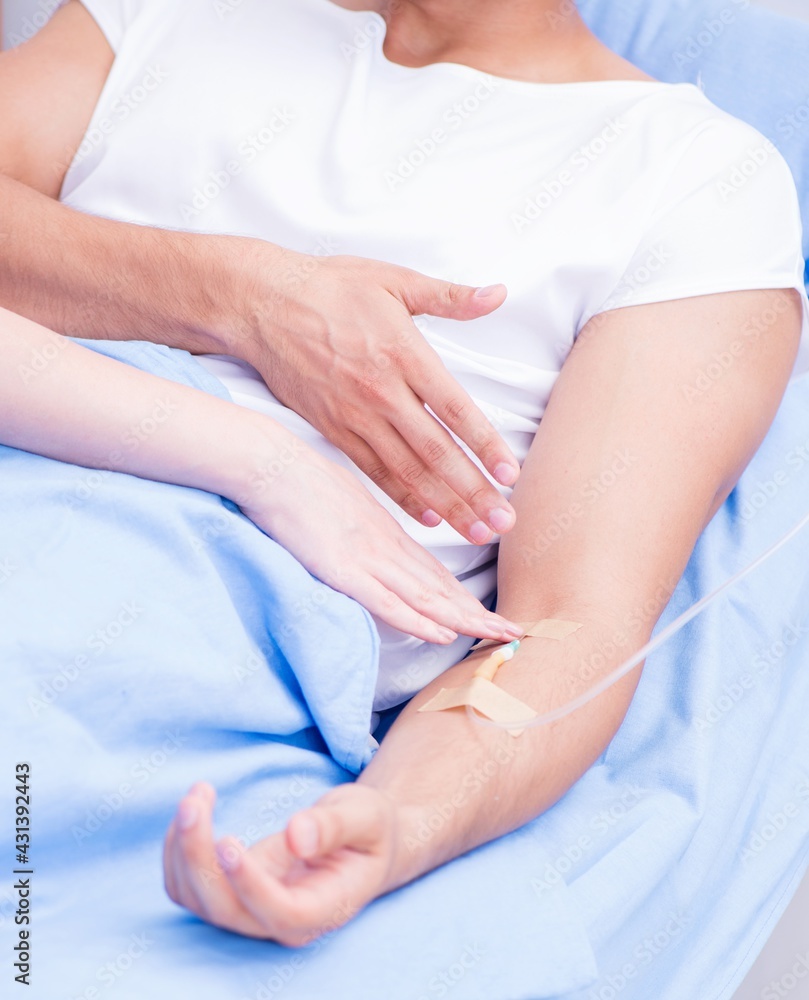 Woman doctor examining male patient in hospital Woman doctor examining male patient in hospital