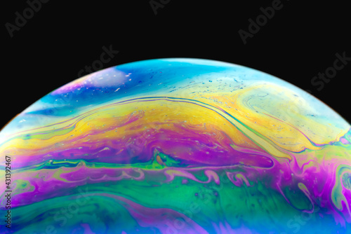 Close up of colorful soap bubble abstract over black background