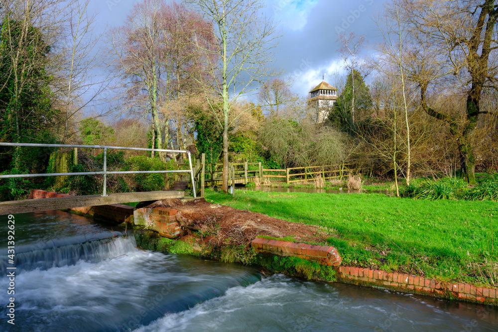 Winter afternoon light on the river Meon at Meonstoke with the church of St Andrew's, Hampshire