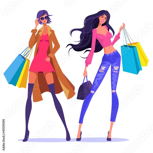 Modernly dressed attractive ladies with shopping bags. Autumn women's clothing creation.