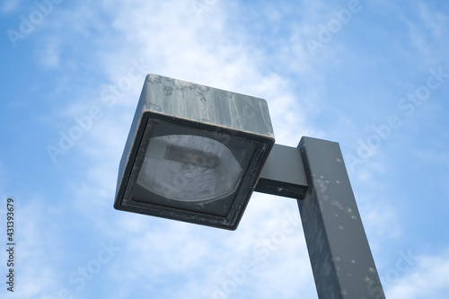 streetlight seen from below with sky and clouds in the background