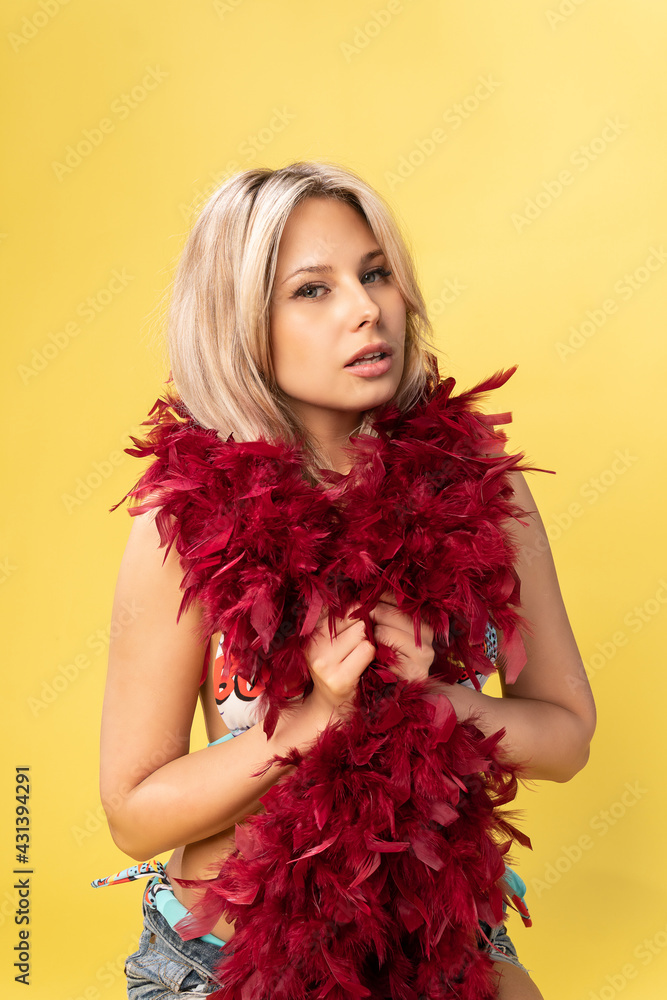 Girl in the hands of boa red-colored chicken feathers blonde young beautiful, style face lady luxury, up pinup. Blond lips ot, emotion vogue party expression retro Girl in the hands of boa red-colored chicken feathers blonde young beautiful, style face lady luxury, up pinup. Blond lips ot, emotion vogue party expression retro