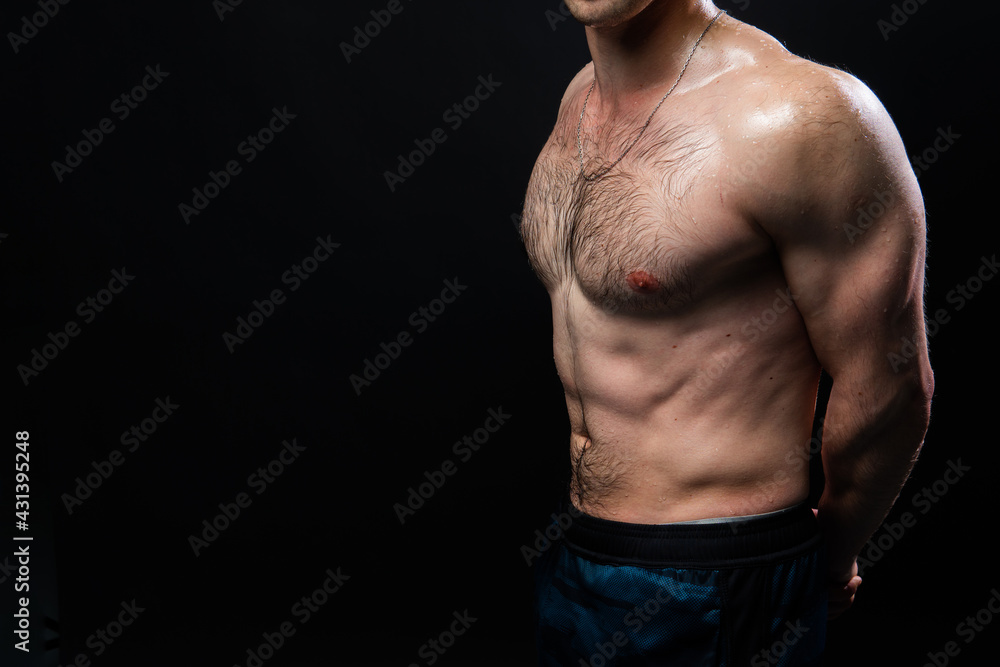 Man on black background keeps dumbbells pumped up in fitness active sport, body weight workout athletic heavy, healthy lifestyle. Young skin one fit Man on black background keeps dumbbells pumped up in fitness active sport, body weight workout athletic heavy, healthy lifestyle. Young skin one fit