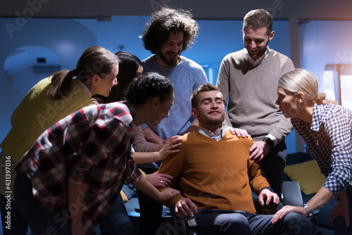 Happy Workers Have Fun  in Modern Office, Handicaped Man on Wheelchair.  Communication with Colleagues. Teamwork and disability Concept photo